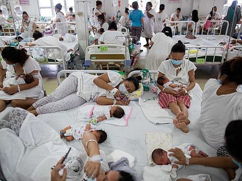 Mothers wearing masks rest with their newborn babies on shared beds inside the maternity ward of the government-run Dr. Jose Fabella Memorial Hospital, amid the coronavirus disease (COVID-19) outbreak, in Manila, Philippines, September 18, 2020. 