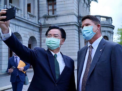 In this photo released by the Taiwan Ministry of Foreign Affairs, Taiwan's Foreign Minister Joseph Wu poses for a selfie with US Under Secretary of State Keith Krach, right, during a meeting in Taipei, Taiwan, Friday, Sept. 18, 2020.