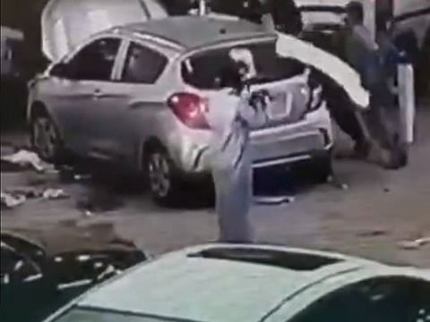 The gunman aims the automatic rifle in a still from the video.