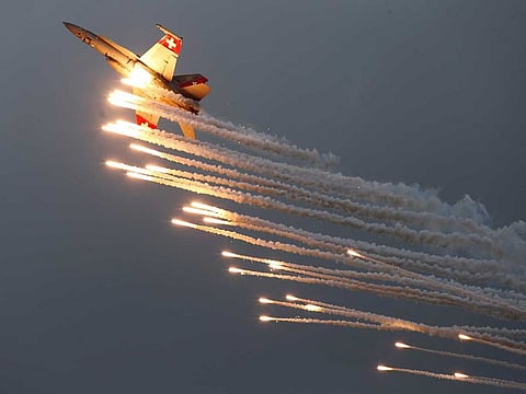 A Swiss Air Force F/A 18 Hornet aircraft releases flare during the Air14 airshow at the airport in Payerne, Switzerland August 31, 2014.  