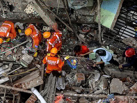 National Disaster Response Force (NDRF) officials and firemen remove debris as they look for survivors after a three-storey residential building collapsed in Bhiwandi on the outskirts of Mumbai, India, September 21, 2020. 