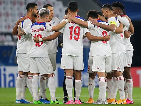Members of Sharjah Club, the Arabian Gulf League Champions, in a huddle before their AFC Champions League match in Doha last week.