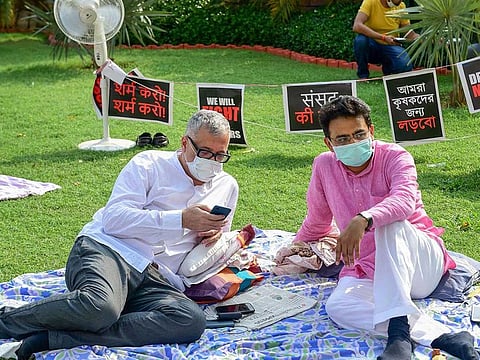 Trinamool Congress (TMC) MP Derek O'Brien and Congress MP Rajiv Satav (R) stage a protest over their suspension from the remaining Monsoon Session of Parliament over the ruckus created in Rajya Sabha, at Parliament House in New Delhi, Tuesday morning, Sept. 22, 2020. 