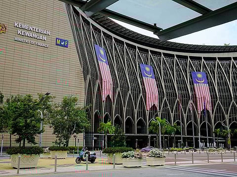 Malaysia flags hang from the Ministry of Finance building complex in Putrajaya, Malaysia, on Wednesday, Sept. 23, 2020. Malaysia’s Prime Minister Muhyiddin Yassin urged people to reject moves to destabilize the country, after opposition leader Anwar Ibrahim said he has the backing of a majority of lawmakers to form a government.