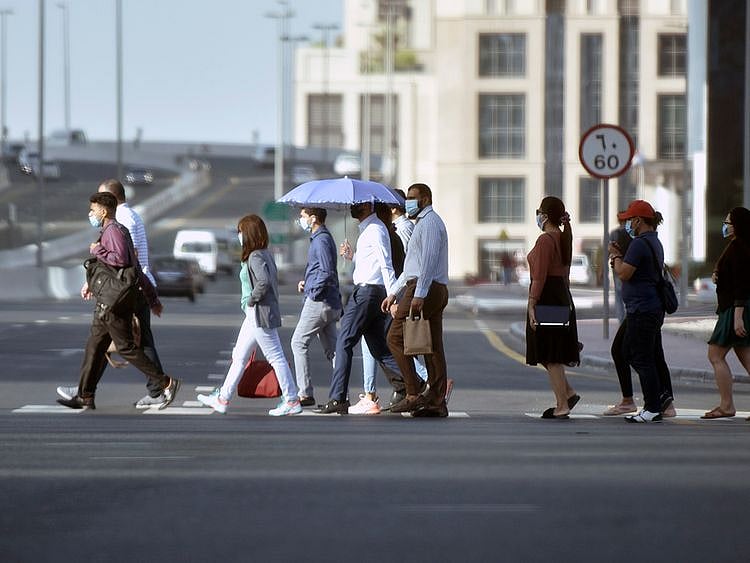 Stock Dubai office staff working street