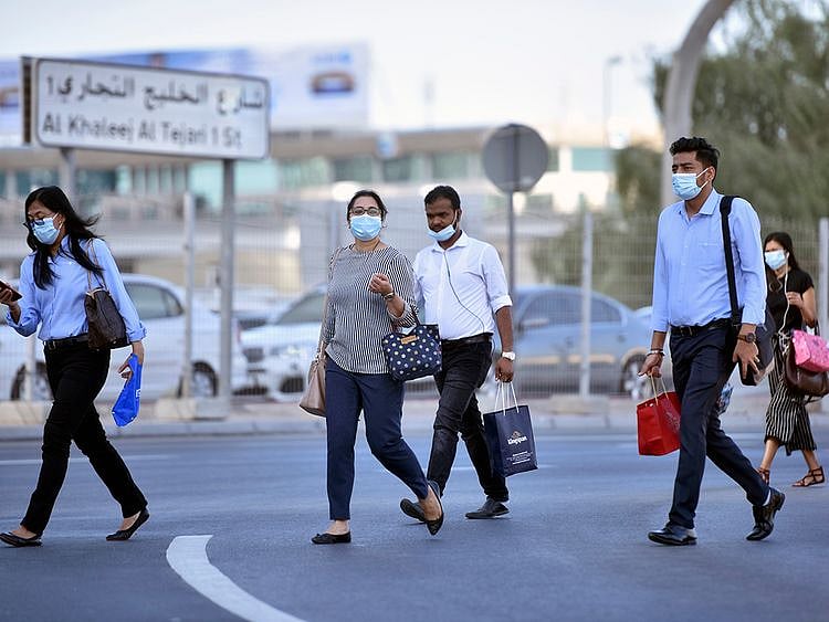 Stock Dubai office staff working street