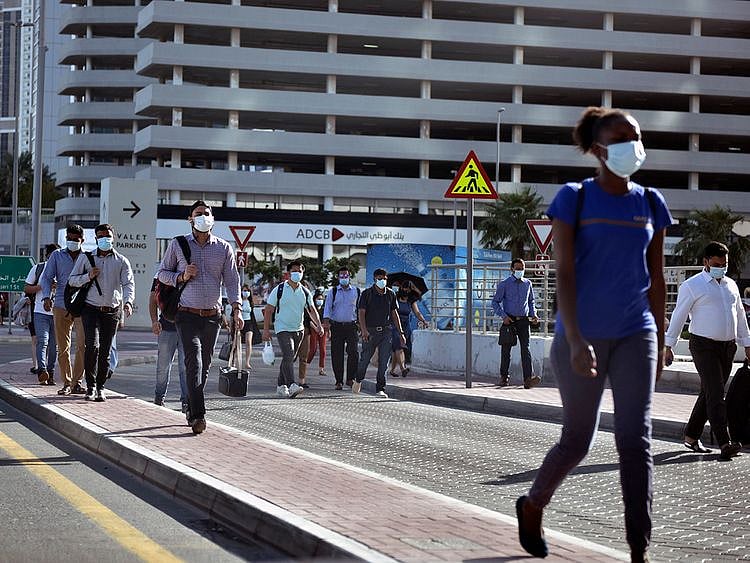 Stock Dubai office staff working street