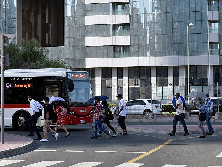 Stock Dubai office staff working street