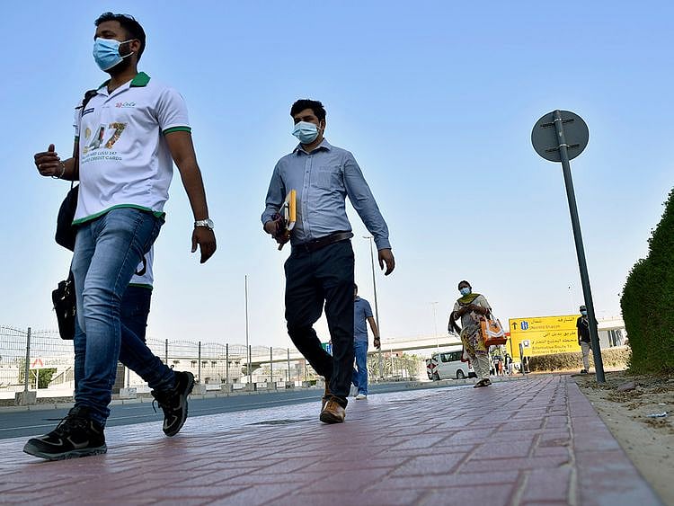 Stock Dubai office staff working street