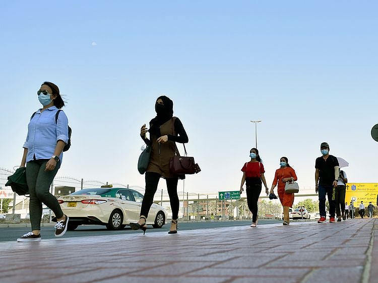 Stock Dubai office staff working street