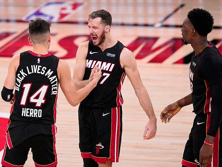Miami Heat's Tyler Herro, left, Goran Dragic and Bam Adebayo celebrate the Game 4 win over Boston Celtics.