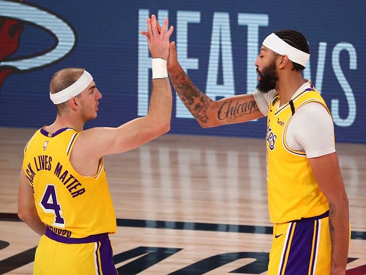 LA Lakers' Alex Caruso and Anthony Davis celebrate after defeating Denver Nuggets in Game 4
