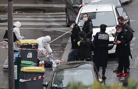 Police officers gather in the area of a knife attack near the former offices of satirical newspaper Charlie Hebdo on September 25, 2020 in Paris.
