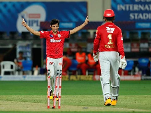 Kings XI Punjab leg spinner Ravi Bishnoi (left) celebrates after one of his wickets against RCB on Thursday.