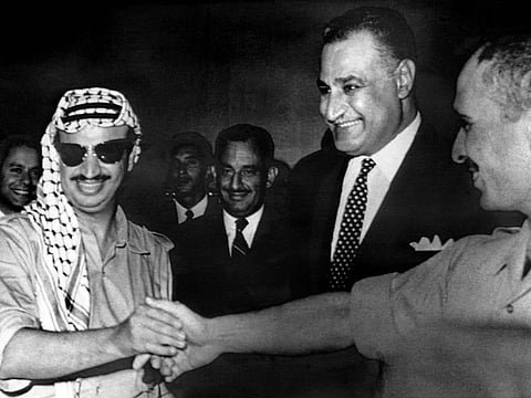 In this file photo taken on September 27, 1970, PLO leader Yasser Arafat (left) and King Hussein of Jordan (right) shake hands, as Egyptian President Gamal Abdul Nasser (centre) looks on, during a meeting of leaders of Arab countries in Cairo after they signed a cease-fire agreement during the Black September events. Nasser died the next day. 