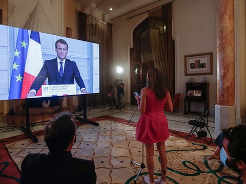 French President Emmanuel Macron listens to a Lebanese journalist's questions during a virtual press conference broadcast at the Pine Residence, the official residence of the French ambassador, in the capital Beirut on September 27, 2020. 