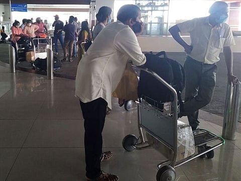 Some Dubai-bound passengers stranded at Cochin International Airport in Kerala on Monday.