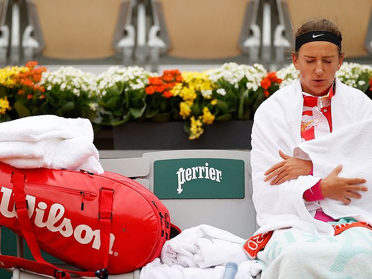 Victoria Azarenka shivers during her first-round match against Danka Kovinic at the French Open.