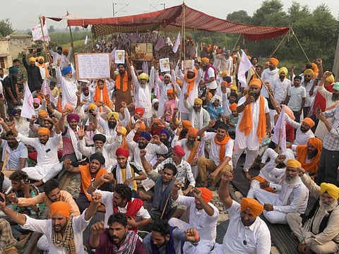 Farmers shout slogans while blocking railway tracks during a protest against Indian Prime Minister Narendra Modi's government following the recent passing of new farm bills in parliament, on the outskirts of Amritsar on September 28, 2020. 