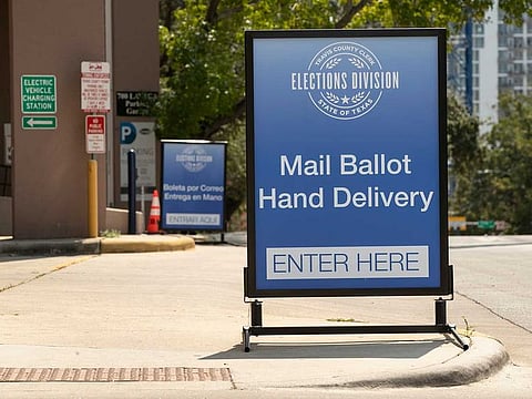 A sign indicates a drive-through ballot drop off location at the 700 Lavaca Parking Garage in Austin, Texas, on Thursday Oct. 1, 2020, shortly after an order was announced by Gov. Greg Abbott restricting such drop off locations. The number of locations where Texas voters can drop off their mail-in ballots has been vastly reduced to ensure poll security, Gov. Greg Abbott said Thursday.