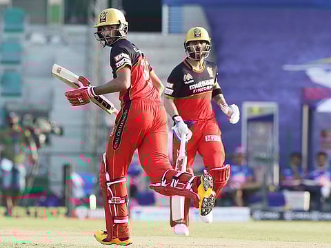 Virat Kohli of Royal Challengers Bangalore and Devdutt Padikkal cross over for a single during their match against Rajasthan Royals in Abu Dhabi on Saturday.  