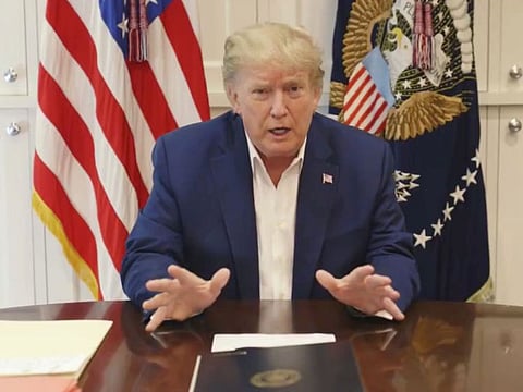 US President Donald Trump, who is being treated for the coronavirus disease in a military hospital outside Washington, speaks from his hospital room, in this still image taken from a video supplied by the White House, October 3, 2020. 