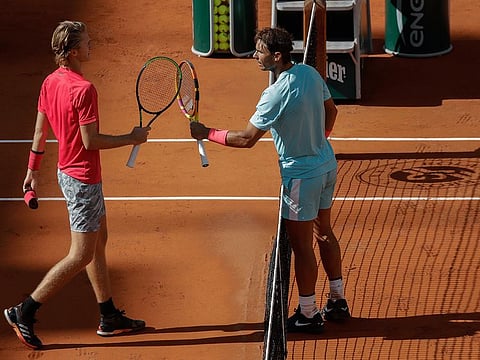Sebastian Korda, the 20-year-old son former player Petr Korda (left) congratulates Spain's Rafael Nadal after the 12-time champion won the fourth round match of the French Open on Sunday.