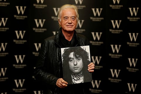 Guitarist Jimmy Page of rock band Led Zeppelin poses for photographers during a book signing for his book "Jimmy Page" at Waterstones in London December 2, 2014.