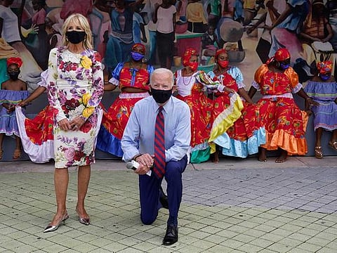 Democratic presidential candidate former Vice President Joe Biden and his wife Jill Biden pose for a photo with dancers as they visit Little Haiti Cultural Complex, Monday, Oct. 5, 2020, in Miami. 