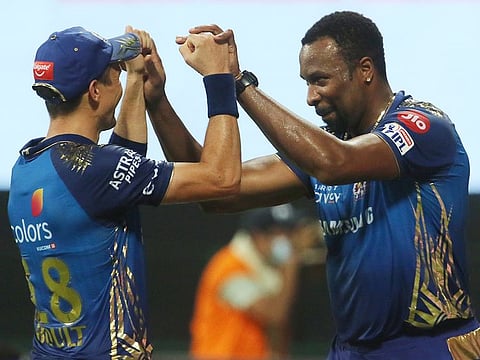 Kieron Pollard (right) and Trent Boult of Mumbai Indians celebrate the wicket of Jos Buttler of Rajasthan Royals. 