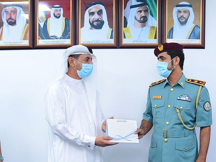 The watch being handed over to a family member of the Emirati woman who lost it