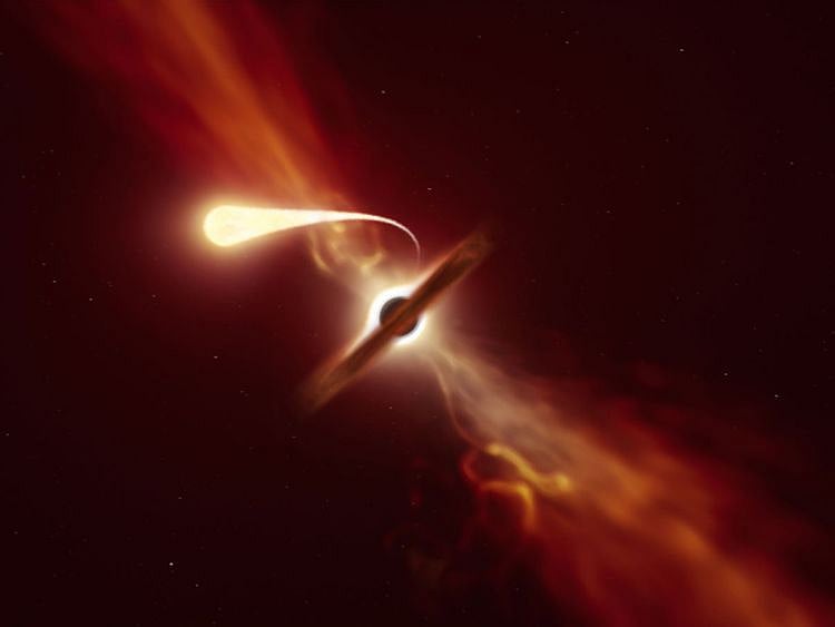 This handout picture released by The European southern Observatory on October 12, 2020, shows an illustration depicting a star (in the foreground) experiencing spaghettification as it’s sucked in by a supermassive black hole (in the background) during a "tidal disruption event".