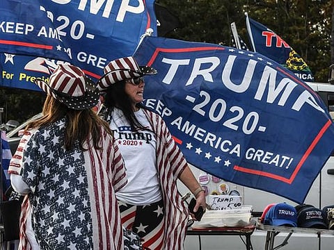 People participate in a pro-Trump rally on October 11, 2020 in Ronkonkoma, New York. With President Trump testing positive for the coronavirus and less than one month left until the U.S. Presidential election, Trump supporters have been organising weekly rallies. 