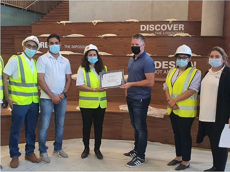 The team celebrates the commitment to health and safety