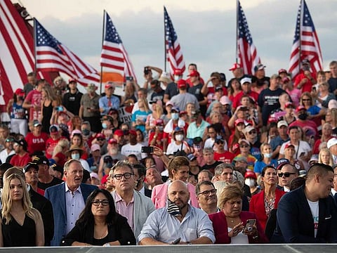 Supporters of US President Donald Trump attend a Make America Great Again rally as he campaigns at Orlando Sanford International Airport in Sanford, Florida, October 12, 2020. 