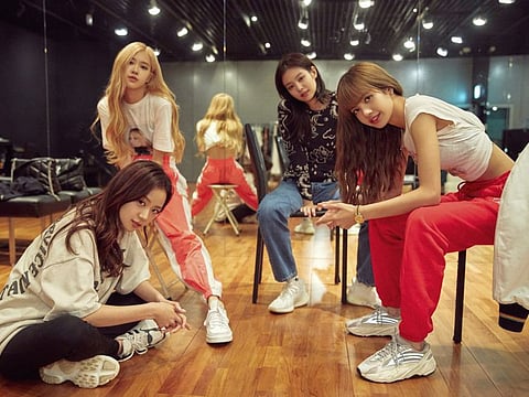 This image released by Netflix shows, from left, Jisoo, seated from left, Rosé, Jennie and Lisa of the K-Pop band Blackpink.