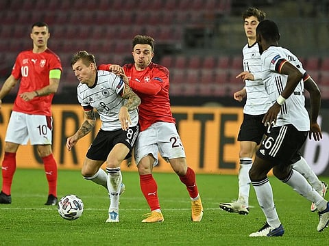Germany'German midfielder Toni Kroos and Switzerland's midfielder Xherdan Shaqiri vie for the ball during their Uefa Nations League match in Cologne on Tuesday. The teams drew 3-3.
