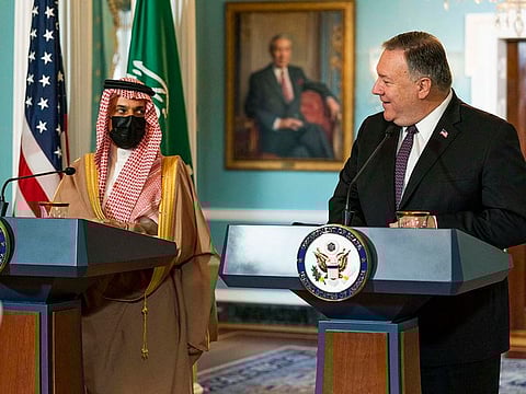 Secretary of State Mike Pompeo, right, glances to Saudi Minister of Foreign Affairs Prince Faisal bin Farhan Al Saud as he speaks during their meeting at the State Department, Wednesday, Oct. 14, 2020, in Washington.