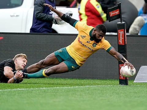 Australia's Marika Koroibete scores a try in the tackle of New Zealand's Damian McKenzie during the Bledisloe Cup rugby game between the All Blacks and the Wallabies in Wellington, New Zealand, Sunday, Oct.11, 2020. (John Cowpland /Photosport via AP)