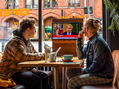 Customers watch a television in a pub streaming a clip of U.K. Prime Minister Boris Johnson making a statement on Brexit, in Manchester, U.K., on Friday, Oct. 16, 2020. 