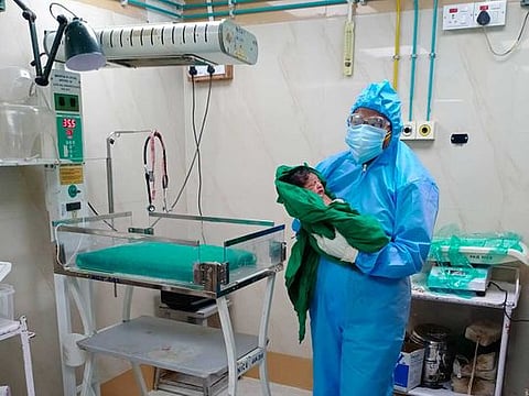 Shayla Srivastava, an obstetrician at BYL Nair Charitable Hospital in Mumbai, holds a baby born to a coronavirus-positive mother on May 31.