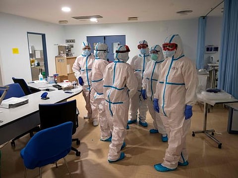 Healthcare workers chat at the Intensive Care Unit (ICU) of the Severo Ochoa University Hospital in Leganes on October 16, 2020. 