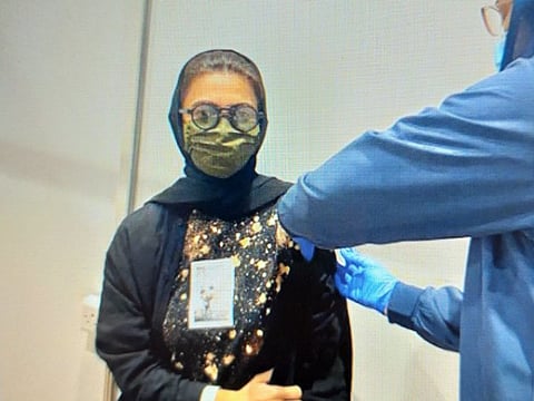 Al Kaabi receives her vaccine shot.