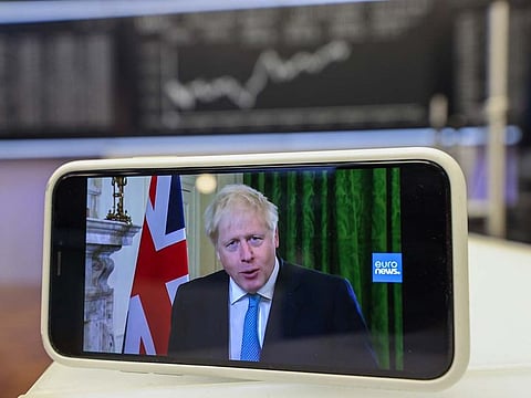 A smartphone displays U.K. Prime Minister Boris Johnson delivering his Brexit negotiation statement in this arranged photograph inside the Frankfurt Stock Exchange, operated by Deutsche Boerse AG, in Frankfurt, Germany, on Friday, Oct. 16, 2020. 