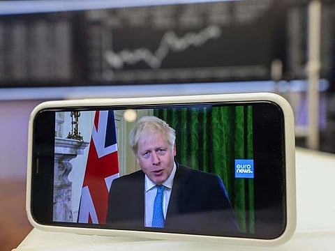 A smartphone displays U.K. Prime Minister Boris Johnson delivering his Brexit negotiation statement in this arranged photograph inside the Frankfurt Stock Exchange, operated by Deutsche Boerse AG, in Frankfurt, Germany, on Friday, Oct. 16, 2020. 