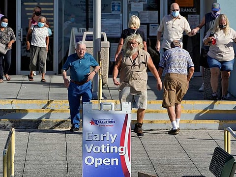 Voters leave the Polk County Government Centre after casting their ballots Monday, Oct. 19, 2020, in Lakeland, Fla.