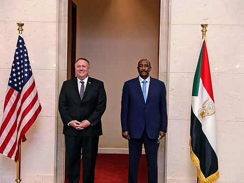 In this August 25, 2020 file photo, US Secretary of State Mike Pompeo stands with Sudanese Gen. Abdul-Fattah Burhan, the head of the ruling sovereign council, in Khartoum, Sudan.  
