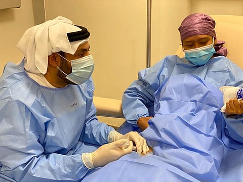 Dr Humaid Al Shamsi delivers the new injection to patient Joanne Resta