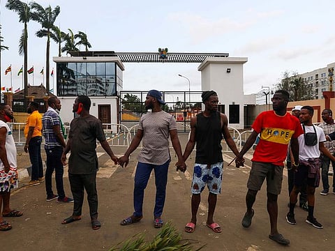 Demonstrators hold hands as they gather near the Lagos State House, despite a round-the-clock curfew imposed by the authorities on the Nigerian state of Lagos in response to protests against alleged police brutality, Nigeria October 20, 2020.