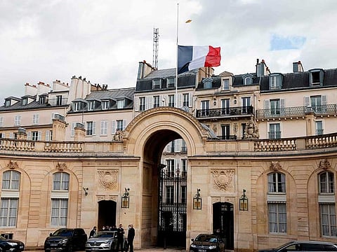 This photograph taken on October 21, 2020 shows the French flag flying at half-mast at the Elysee palace in Paris to pay tribute to slain history teacher Samuel Paty, who was beheaded by an attacker for showing pupils cartoons of the Prophet Mohammed (PBUH) in his civics class, on October 16, 2020, in Conflans-Sainte-Honorine, northwest of Paris. 